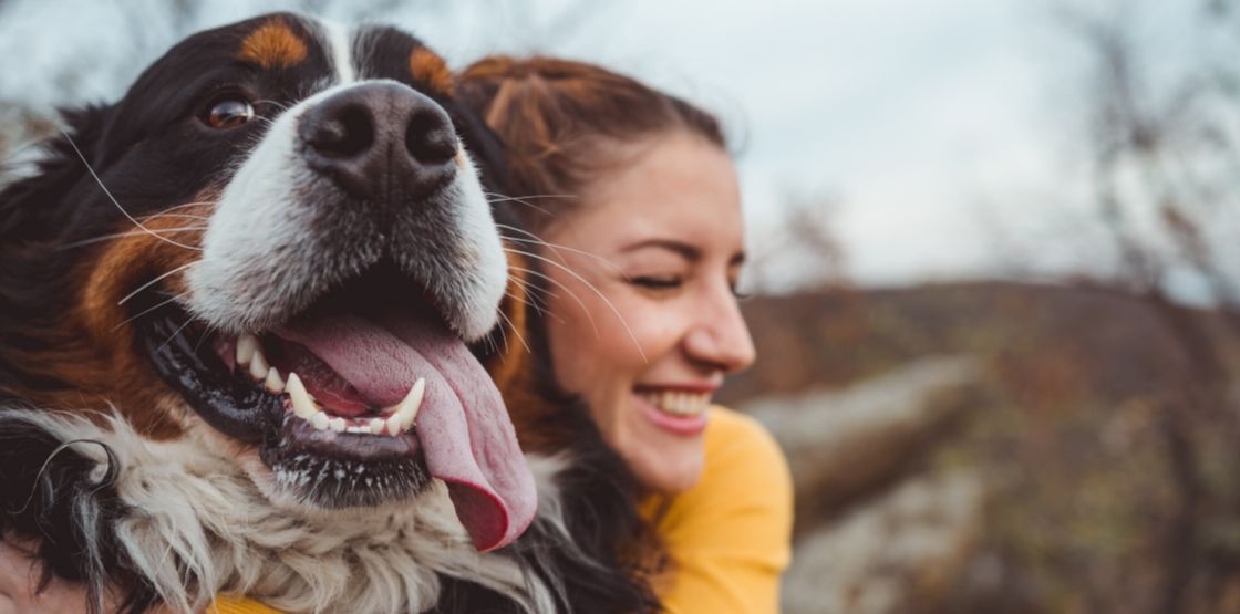 A woman hugging her dog.